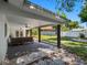 Backyard with a covered patio, ceiling fans, seating, and green space at 1154 64Th S Ave, St Petersburg, FL 33705