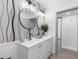 Double sink bathroom vanity with modern fixtures, stylish wallpaper, and neutral decor at 1154 64Th S Ave, St Petersburg, FL 33705