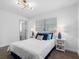 Inviting bedroom features a queen bed, bedside tables with lamps, and a window with blinds at 1154 64Th S Ave, St Petersburg, FL 33705