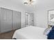 Bedroom featuring updated lighting, neutral carpet, and sliding door closet at 1154 64Th S Ave, St Petersburg, FL 33705