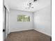 Cozy bedroom with neutral carpet, updated lighting, and a bright window view at 1154 64Th S Ave, St Petersburg, FL 33705