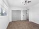 Minimalist bedroom with neutral carpet, updated lighting, and a sliding door closet at 1154 64Th S Ave, St Petersburg, FL 33705
