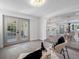 Bright entryway featuring french doors, modern lighting, and neutral-toned floors opening into the dining and kitchen areas at 1154 64Th S Ave, St Petersburg, FL 33705