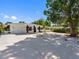 Inviting single-story home featuring well-maintained landscaping, mature trees, and a white rock yard at 1154 64Th S Ave, St Petersburg, FL 33705
