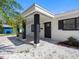 Stylish front entrance with dark pillars, white rock landscaping, and a sidewalk to the front door at 1154 64Th S Ave, St Petersburg, FL 33705