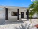 Inviting front entrance with dark pillars, white rock landscaping, and sidewalk to the driveway at 1154 64Th S Ave, St Petersburg, FL 33705
