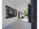 Comfortable front porch with dark pillars, exterior rock landscaping, and a glimpse of the neighboring house at 1154 64Th S Ave, St Petersburg, FL 33705