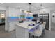 Modern kitchen with sleek white cabinets, stainless steel appliances, and marble countertops on kitchen island at 1154 64Th S Ave, St Petersburg, FL 33705