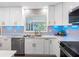 Bright kitchen with stainless steel dishwasher, modern countertops, and ample cabinet space at 1154 64Th S Ave, St Petersburg, FL 33705
