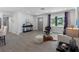 Bright living room features modern decor, wood-look floors, and lots of natural light from the large windows at 1154 64Th S Ave, St Petersburg, FL 33705