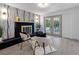Living room featuring fireplace, modern decor, stylish light fixtures, and patio doors at 1154 64Th S Ave, St Petersburg, FL 33705