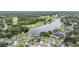 Expansive aerial view showcasing a home in a community near a golf course and lake at 1222 Rainbrook Cir, Valrico, FL 33596