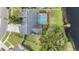 Overhead view of a home featuring a screened pool and a waterfront dock at 1222 Rainbrook Cir, Valrico, FL 33596