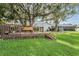 Beautiful backyard with a wooden deck swing under a mossy tree at 1222 Rainbrook Cir, Valrico, FL 33596