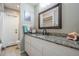 Bathroom with tile floors, granite countertop, large mirror, and a walk-in shower at 1222 Rainbrook Cir, Valrico, FL 33596