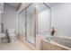 Bathroom featuring a marble bathtub and glass-enclosed shower next to a toilet at 1222 Rainbrook Cir, Valrico, FL 33596