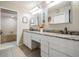 Bright bathroom with a double sink vanity, granite countertop, and soaking tub at 1222 Rainbrook Cir, Valrico, FL 33596