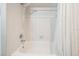 Clean white bathtub with shower and curtain, featuring a classic, simple design at 1222 Rainbrook Cir, Valrico, FL 33596