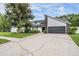 Charming home with an attached garage, manicured lawn, and mature trees creating curb appeal at 1222 Rainbrook Cir, Valrico, FL 33596