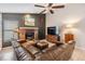 Inviting living room offers a fireplace, TV, and comfortable leather seating at 1222 Rainbrook Cir, Valrico, FL 33596