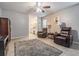 Open living room leads to the bathroom, with comfortable seating and tile flooring at 1222 Rainbrook Cir, Valrico, FL 33596