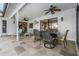 Covered patio with dining set, lounge chairs, ceiling fans, and views of the outdoors at 1222 Rainbrook Cir, Valrico, FL 33596