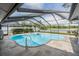 A beautiful screened-in pool with lake views offers a relaxing outdoor space at 1222 Rainbrook Cir, Valrico, FL 33596
