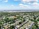 Aerial view showcases a neighborhood near the water with a mix of homes, trees, and access to open spaces at 12316 Eldon Dr, Largo, FL 33774