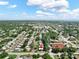Aerial view of a home close to the water and downtown on a partly cloudy day at 12316 Eldon Dr, Largo, FL 33774
