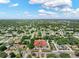An aerial view of a residential area with tree-lined streets, a well-maintained commercial building and landscaped surroundings at 12316 Eldon Dr, Largo, FL 33774