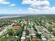 An aerial view of a property in a neighborhood close to the water on a partly cloudy day at 12316 Eldon Dr, Largo, FL 33774