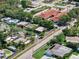 Aerial view of residential area with tree-lined streets and well-maintained houses; additional commercial building visible at 12316 Eldon Dr, Largo, FL 33774