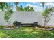 Picture of a backyard featuring a white privacy fence, lush grass and a decorative rock bench with plantings at 12316 Eldon Dr, Largo, FL 33774