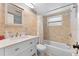 Bright bathroom with tiled shower, shower curtain, vanity with sink, and a window at 12316 Eldon Dr, Largo, FL 33774