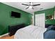 Cozy bedroom includes wood-style flooring, a ceiling fan, and built-in shelves at 12316 Eldon Dr, Largo, FL 33774