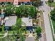 Overhead view showcasing a single-story home with two cars parked in driveway in a neighborhood lined with trees and sidewalks at 12316 Eldon Dr, Largo, FL 33774