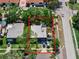 Overhead view showcasing a single-story home with two cars parked in driveway in a neighborhood lined with trees and sidewalks at 12316 Eldon Dr, Largo, FL 33774