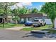 Charming home featuring a well-manicured front yard, a quaint porch, and a modern, updated exterior at 12316 Eldon Dr, Largo, FL 33774