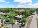 Aerial image of a cozy single-Gathering home with mature trees and a long driveway on a sunny day at 12316 Eldon Dr, Largo, FL 33774