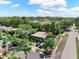 Aerial image of a lovely single-Gathering home with mature trees and a long driveway on a sunny day at 12316 Eldon Dr, Largo, FL 33774