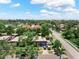 Aerial image of a lovely single-Gathering home with mature trees and a long driveway on a sunny day at 12316 Eldon Dr, Largo, FL 33774
