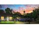 Cozy home with a well-kept lawn and a striking sunset backdrop, enhancing its curb appeal and inviting ambiance at 12316 Eldon Dr, Largo, FL 33774
