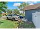 Features a side view of the house with a paved driveway and two cars parked in front at 12316 Eldon Dr, Largo, FL 33774