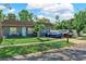 Well-maintained home featuring vibrant landscaping, a cozy front porch, and a welcoming exterior at 12316 Eldon Dr, Largo, FL 33774