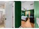 Hallway leading into bedroom with wood-style flooring and door to bath at 12316 Eldon Dr, Largo, FL 33774