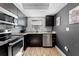 Beautiful kitchen features stainless steel appliances, dark cabinets, and gray countertop at 12316 Eldon Dr, Largo, FL 33774