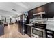 Open kitchen design leads to living area, featuring stainless steel appliances and granite countertops at 12316 Eldon Dr, Largo, FL 33774