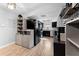 Open kitchen boasts modern appliances and wood-style flooring with ample storage and eat-in space at 12316 Eldon Dr, Largo, FL 33774