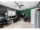 Office featuring hardwood floors, custom desk, a ceiling fan, shelving, and natural light from the windows at 12316 Eldon Dr, Largo, FL 33774
