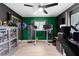 The office boasts sleek hardwood floors, ample storage, with custom shelving, and a large window at 12316 Eldon Dr, Largo, FL 33774